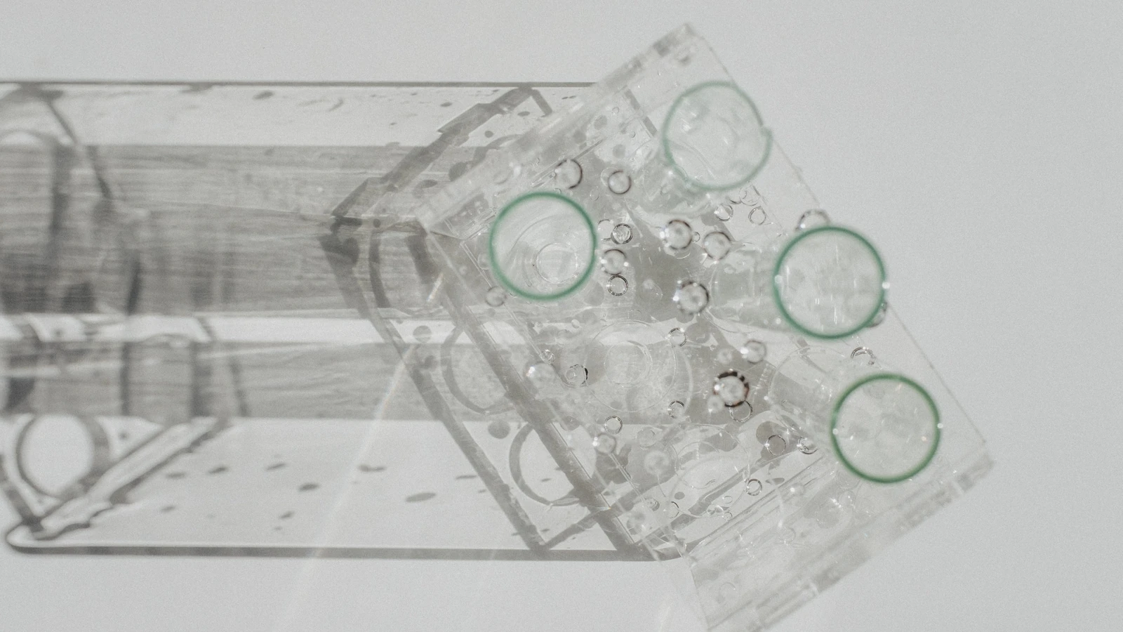 Clear laboratory glassware arranged on a white surface.